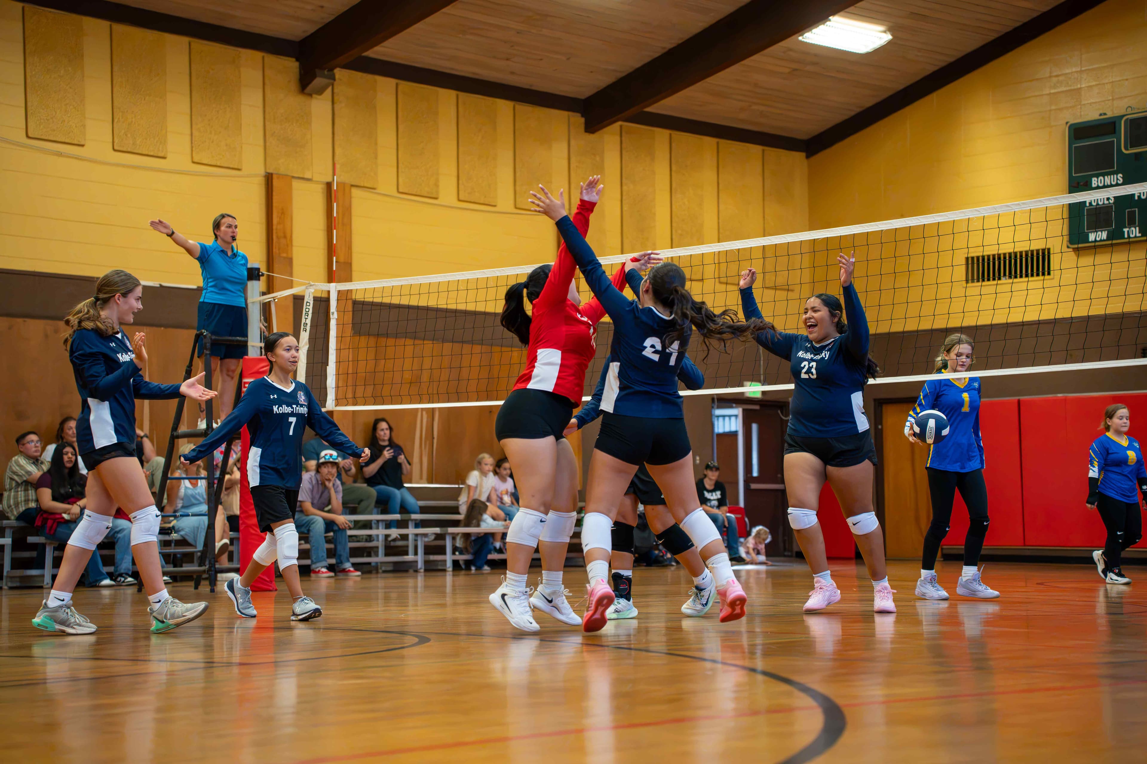 Crusaders rise up together for a block at the net.